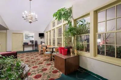 a room with windows and a table with plants at Knights Inn Hadley in Hadley