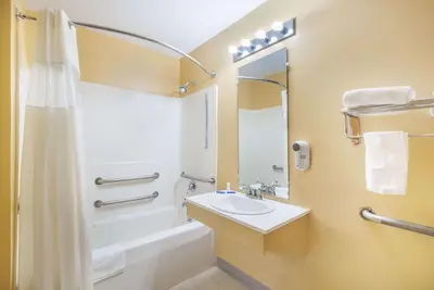a bathroom with a sink and a tub and a shower at Knights Inn Hadley in Hadley