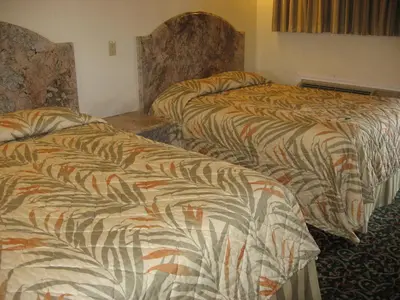 a hotel room with two beds in a room at Domino Inn in North Bergen
