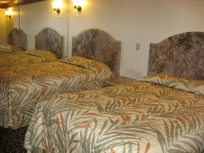 a hotel room with two beds in a room at Domino Inn in North Bergen