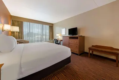 a hotel room with a bed and a desk and a television at Best Western Executive Hotel New Haven-West Haven in West Haven