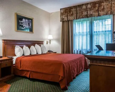 a hotel room with a bed and a window at Econo Lodge Glens Falls - Lake George in Glens Falls
