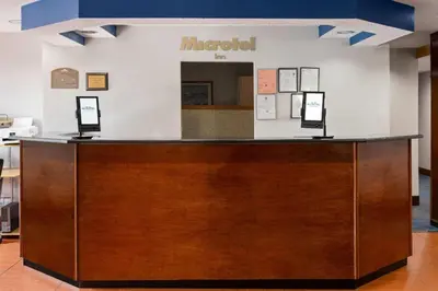 a lobby with a reception desk with a mirror at Microtel Inn by Wyndham - Albany Airport in Latham