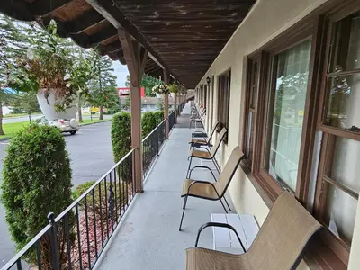 a row of benches sitting on a balcony at Alpenhaus Motel in Queensbury