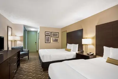 a hotel room with two beds and a television at La Quinta by Wyndham Springfield in Springfield