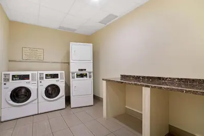 a laundry room with a washer and dryer at La Quinta by Wyndham Springfield in Springfield