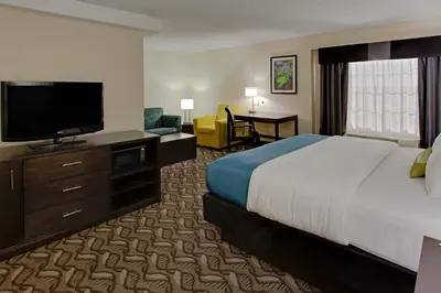 a hotel room with a bed and a flat screen tv at La Quinta by Wyndham Springfield in Springfield