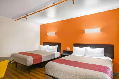 two beds in a room with orange walls at Motel 6-Ilion, NY in Ilion