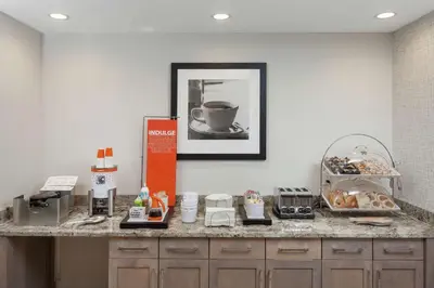 a kitchen with a counter with a counter top with food at Hampton Inn & Suites Rocky Hill - Hartford South in Rocky Hill