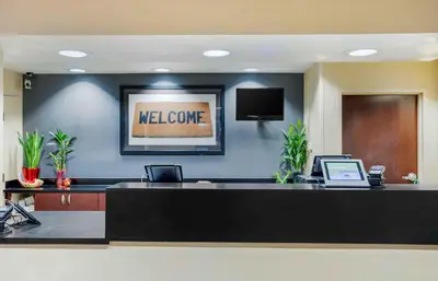 a lobby with a reception desk with a welcome sign at Extended Stay America Suites - New York City - LaGuardia Airport in Queens