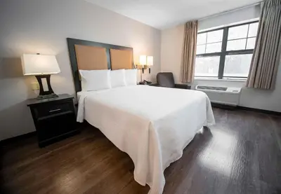 a bedroom with a large white bed and a window at Extended Stay America Suites - White Plains - Elmsford in Elmsford