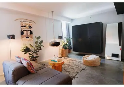 a living room with a couch and a flat screen tv at Hotel Alameda, Highline in New York