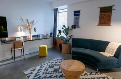a living room with a couch and a table at Hotel Alameda, Highline in New York
