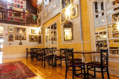 a restaurant with a table and chairs in a room at Amsterdam Castle NY in Amsterdam