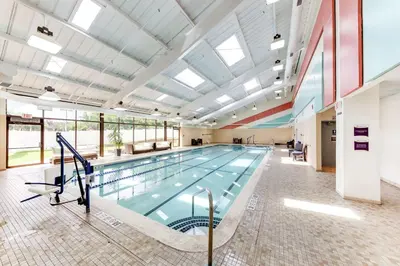 a large swimming pool in a building at DoubleTree by Hilton Binghamton in Binghamton