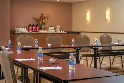 a meeting room with bottles of water on tables at Hyatt Place Saratoga/Malta in Malta