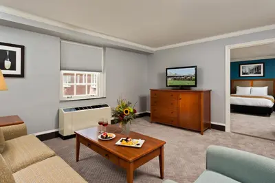 a living room with a couch and a table at Gideon Putnam Resort & Spa in Saratoga Springs