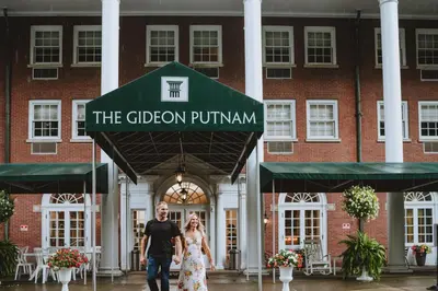 a man and a woman walking in front of a building at Gideon Putnam Resort & Spa in Saratoga Springs