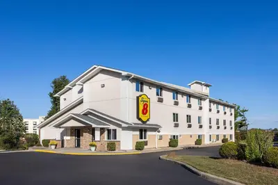 a white building with a fast food restaurant at Super 8 by Wyndham Latham - Albany Airport in Latham