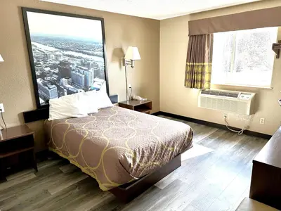 a hotel room with a bed and a large window at Super 8 by Wyndham Latham - Albany Airport in Latham