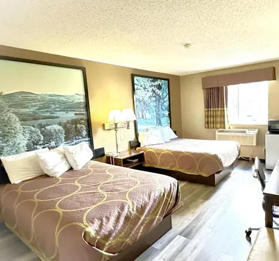 a hotel room with two beds and two windows at Super 8 by Wyndham Latham - Albany Airport in Latham