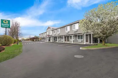a building with a parking lot in front of it at Quality Inn Queensbury - Lake George Area in Queensbury