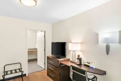 a hotel room with a desk with a tv and a bed at Quality Inn Queensbury - Lake George Area in Queensbury