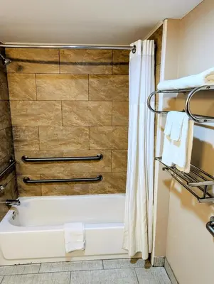 a bathroom with a tub and a shower curtain at Pocono Inn & Banquet - Stroudsburg in Delaware Water Gap