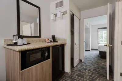 a hotel room with a sink and a mirror at Country Inn & Suites by Radisson, Queensbury - Lake George , NY in Lake George