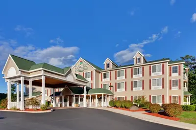 a rendering of a hotel with a parking lot at Country Inn & Suites by Radisson, Queensbury - Lake George , NY in Lake George