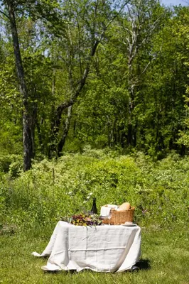 a picnic table with a basket of flowers and a bird at The Litchfield Inn in Litchfield