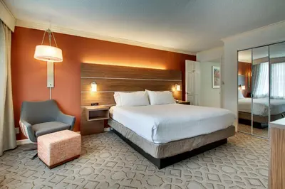 a hotel room with a bed and a chair at Holiday Inn Express Poughkeepsie by IHG in Poughkeepsie