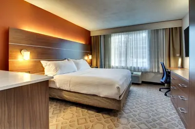 a hotel room with a bed and a desk at Holiday Inn Express Poughkeepsie by IHG in Poughkeepsie