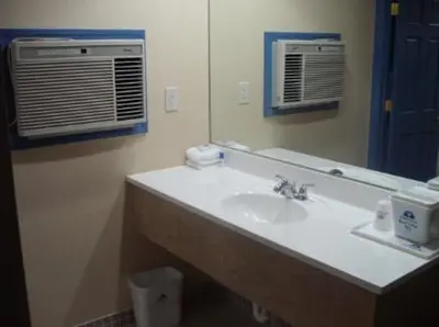 a bathroom with a sink and a mirror at Golden Hill Inn-Danbury in Danbury
