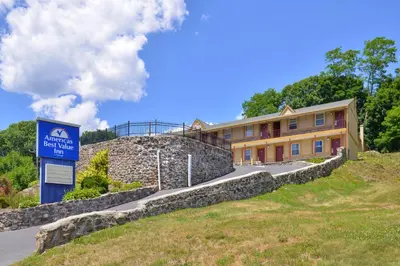 a building on a hill with a sign in front of it at Golden Hill Inn-Danbury in Danbury