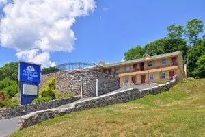 a building on a hill with a sign in front of it at Golden Hill Inn-Danbury in Danbury