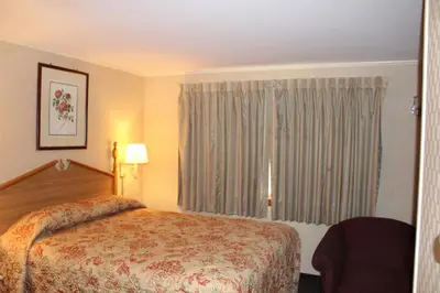 a hotel room with a bed and a window at Elm Motel in Westfield