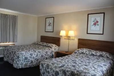 a hotel room with two beds and two lamps at Elm Motel in Westfield