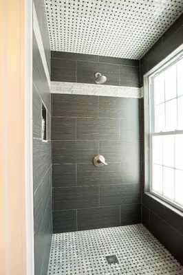 a bathroom with a shower with gray tiles at Naomi's Inn Bed & Breakfast in Springfield
