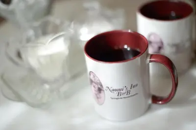 two cups of coffee sitting on a table at Naomi's Inn Bed & Breakfast in Springfield