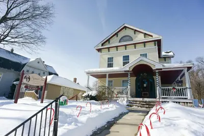 a large house with snow on the ground at Naomi's Inn Bed & Breakfast in Springfield