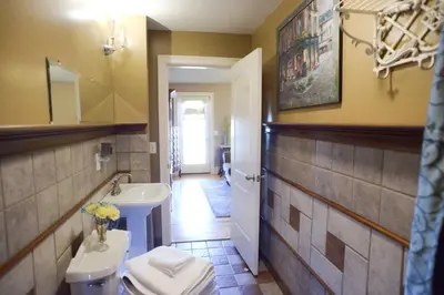 a bathroom with a white toilet and a sink at Naomi's Inn Bed & Breakfast in Springfield