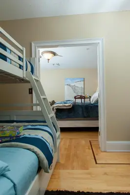 a bedroom with a bunk bed and a mirror at Naomi's Inn Bed & Breakfast in Springfield