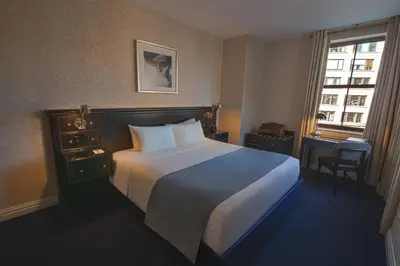 a hotel room with a large bed and a window at The Frederick Hotel Tribeca in New York