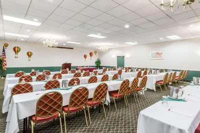 a banquet hall with white tables and chairs at Baymont by Wyndham Queensbury/Lake George in Queensbury