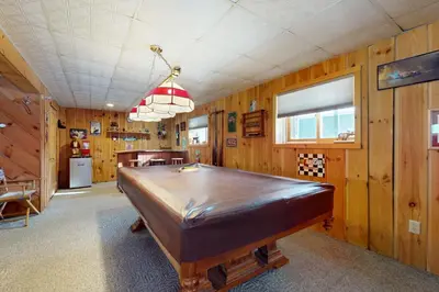 a pool table in a room with wooden walls at West Dover Getaway in West Dover