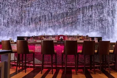 a stage with chairs in front of a waterfall at Resorts World Catskills in Monticello