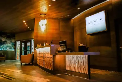 a bar in a restaurant with a sign on the wall at Resorts World Catskills in Monticello
