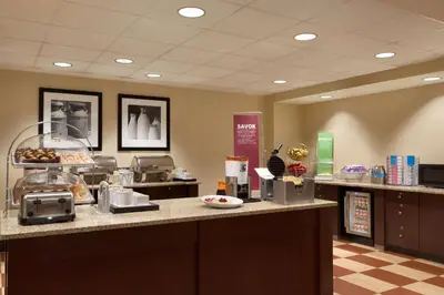 a cafeteria with aasteryasteryasteryasteryasteryasteryasteryasteryasteryasteryasteryastery at Hampton Inn & Suites East Hartford in East Hartford