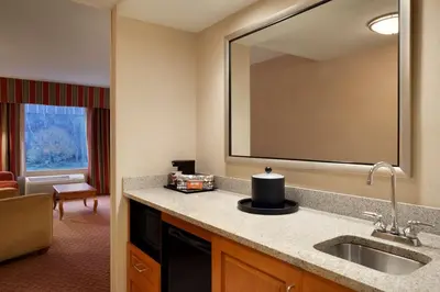 a hotel room with a sink and a mirror at Hampton Inn & Suites East Hartford in East Hartford